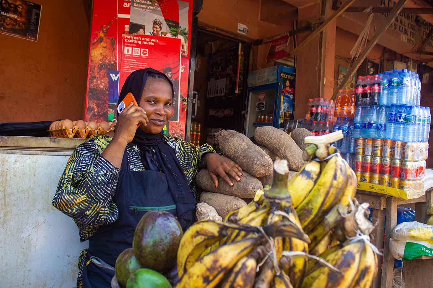 Nigeria Market Woman In Front of Shop Holding Phone to Ear