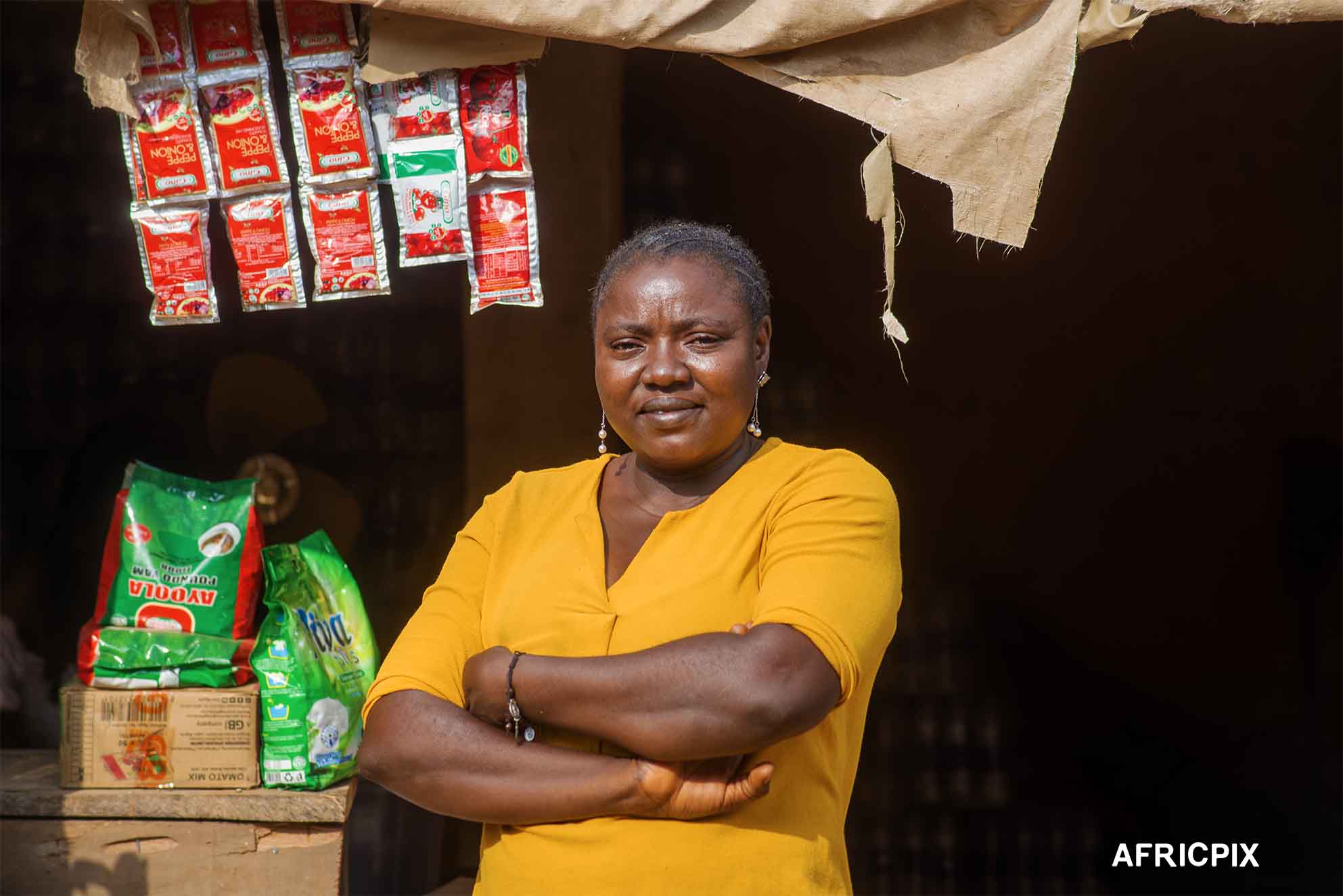 Nigeria Market Woman Standing in Front of Shop