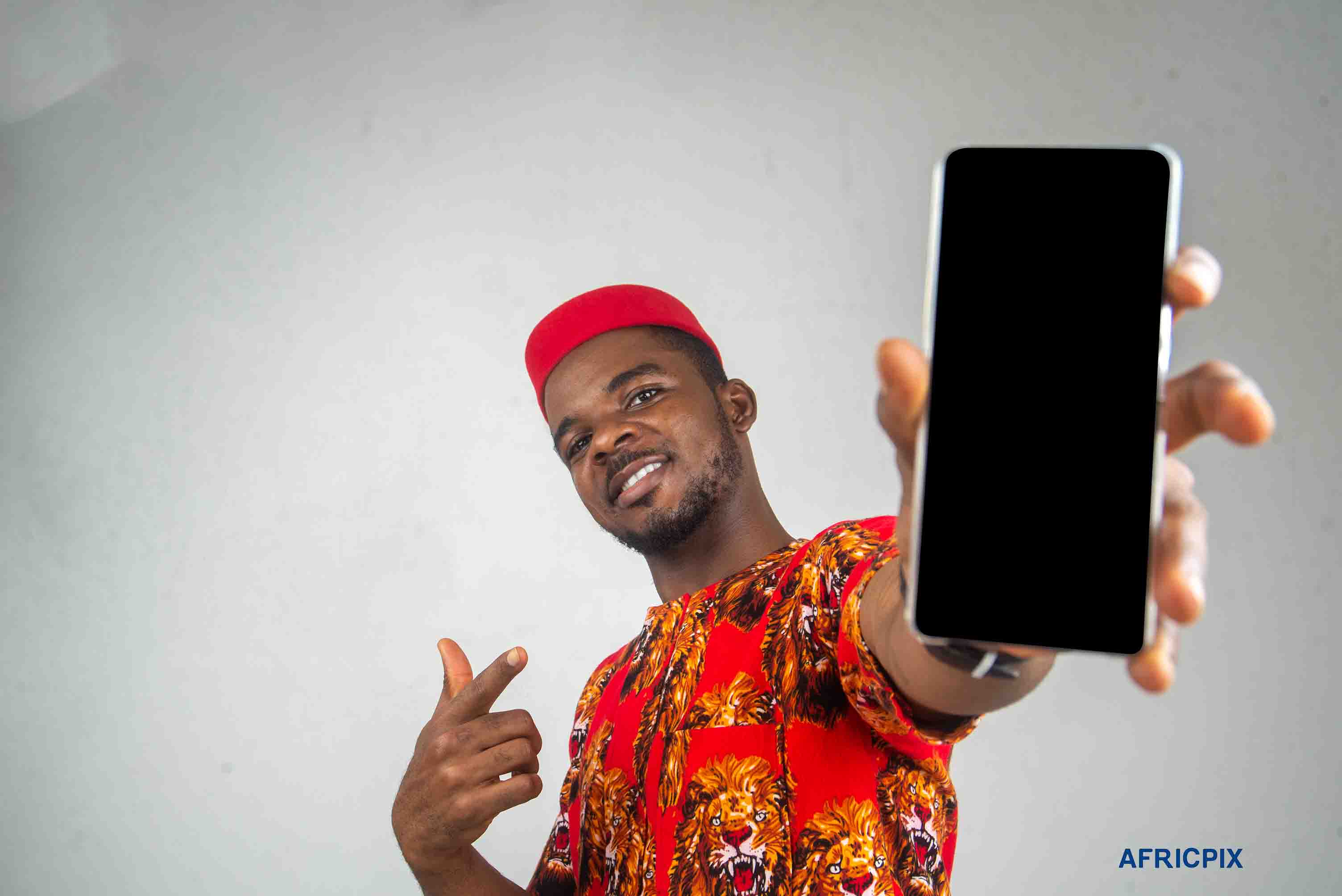 Nigeria Igbo Man Pointing Phone to Camera Happy