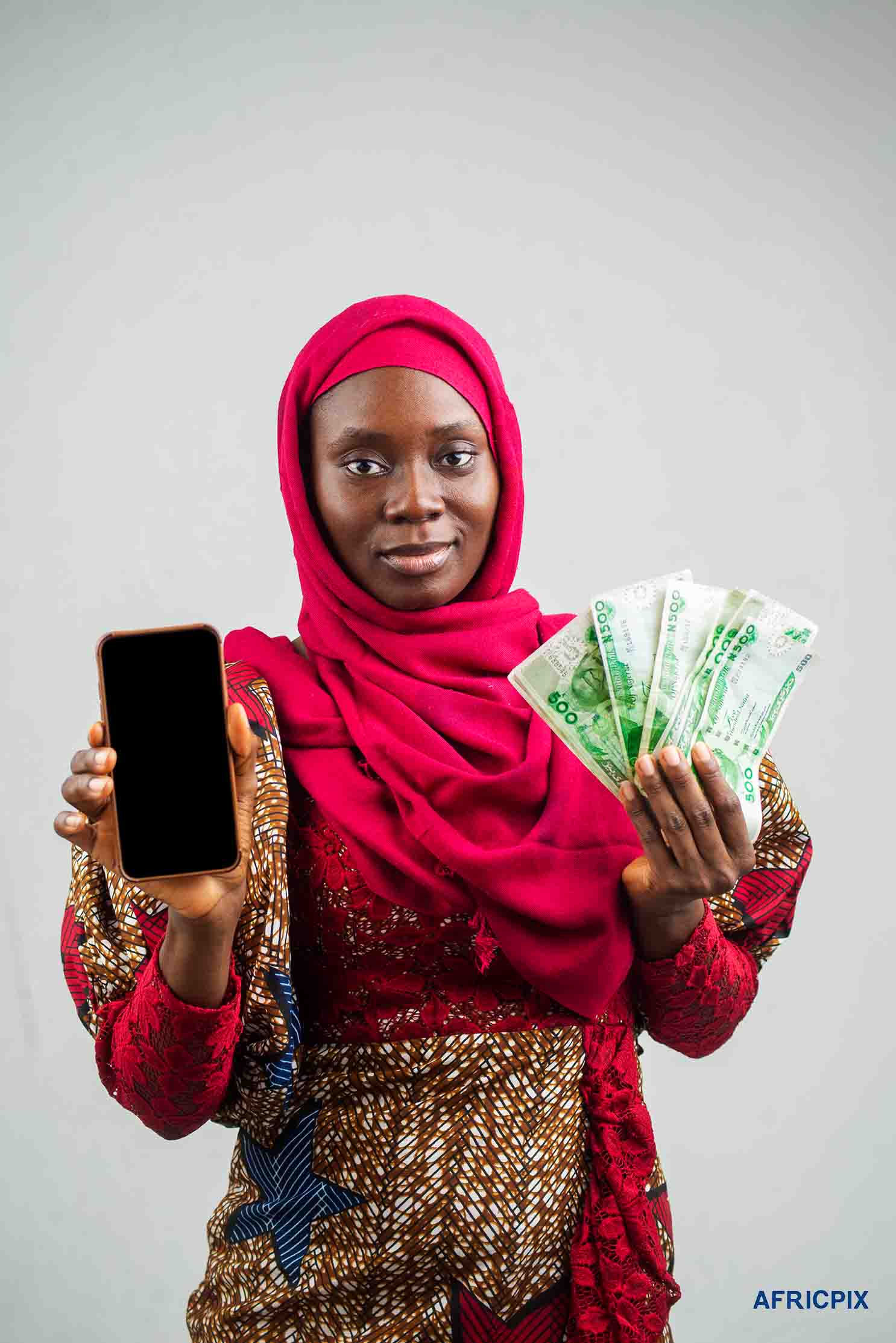 Nigeria Woman Hausa_Holding Money and Phone