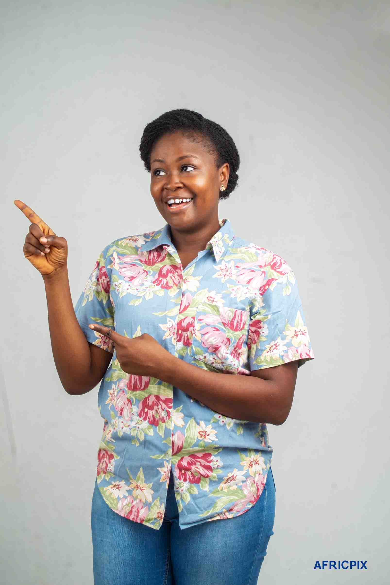 Nigeria Woman Pointing Up Wearing Jeans and T-shirt